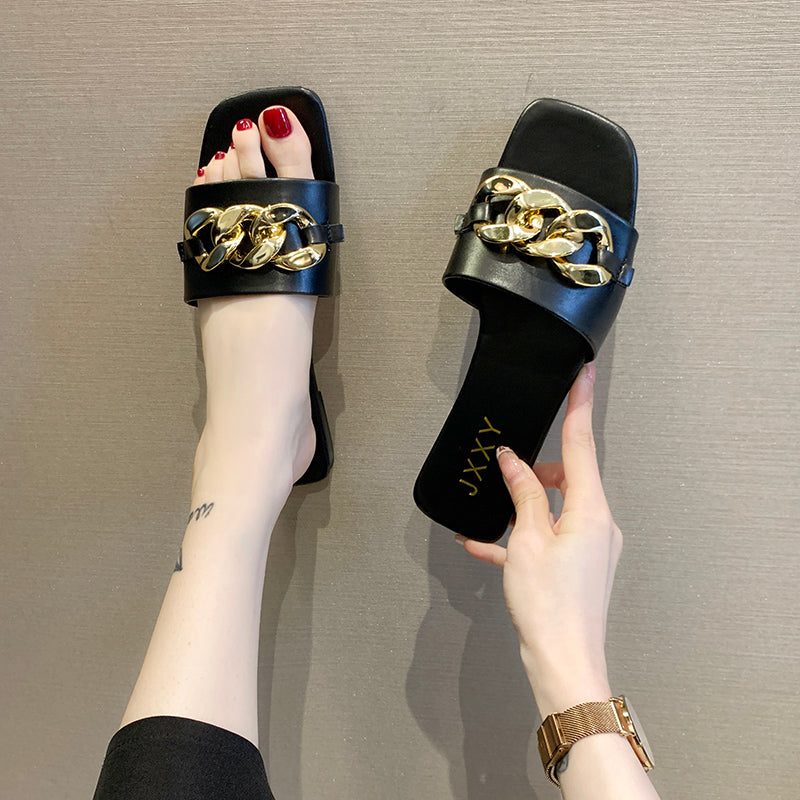 Nuevas pantuflas de moda para mujer 2025: sandalias planas tipo pala con punta cuadrada, detalle de cadena y adorno metálico; calzado casual y playero.